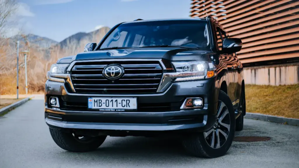 a black toyota park on the road