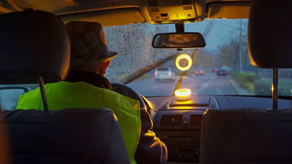 a driver is driving a car at night