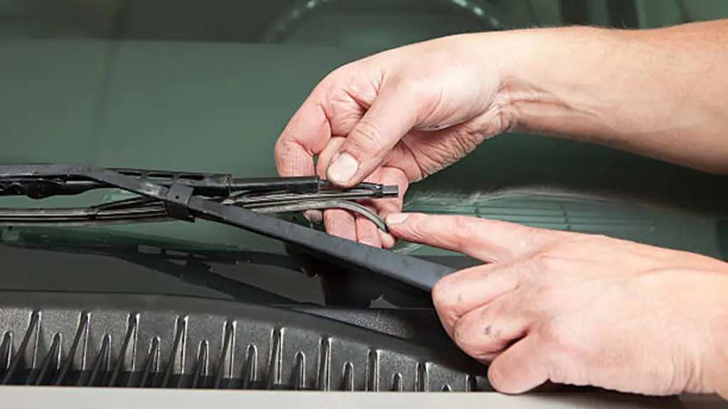 Mechanic’s Hand Holding Broken Windshield Wiper Blade